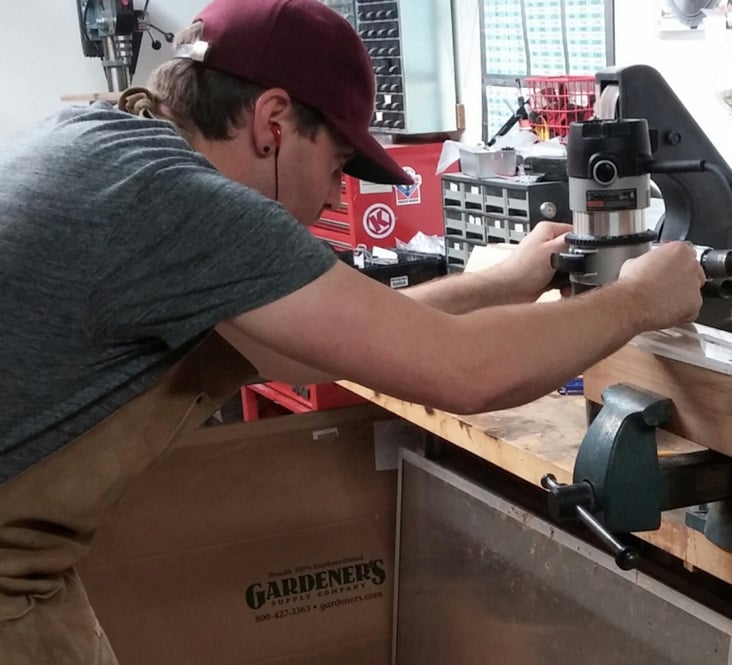 Employee using router to make prototype parts