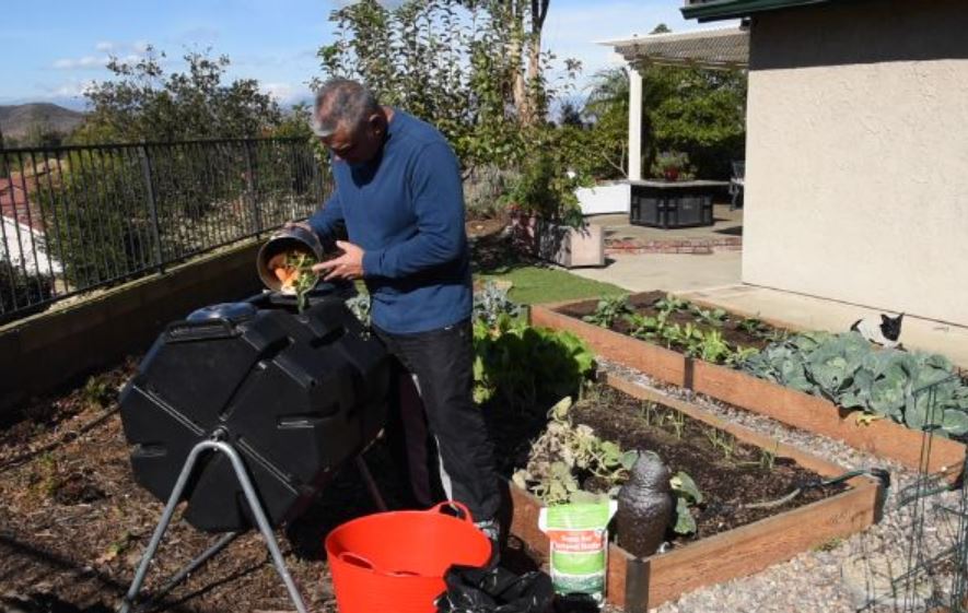 feeding a tumbling composter 