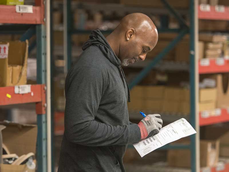 Employee smiling using checklist