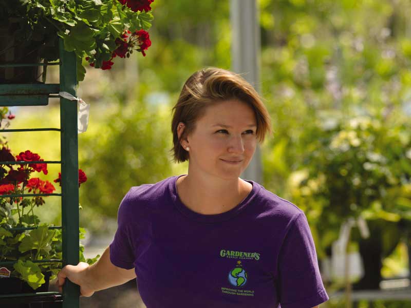 Employee pulling plant cart